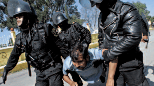 Police detain a protestor in San Salvador de Atenco, Mexico, May 2006. The CNDH conducted an investigation into allegations of human rights violations that occurred during this event. 