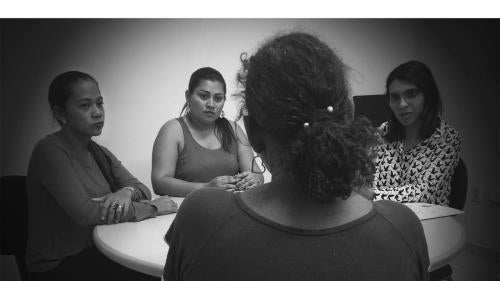 Staff from the Humanitarian Support Center for Women (CHAME, in Portuguese) listen to a woman in Boa Vista, Roraima, on February 17, 2017. CHAME provides legal, psychological, and social support to survivors of domestic violence. 