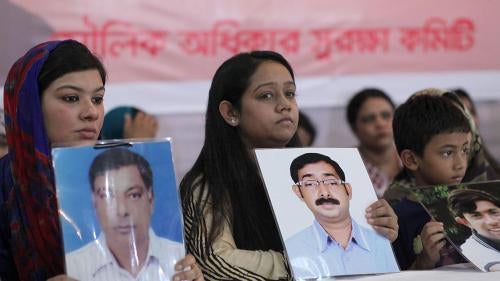 Relatives hold portraits of disappeared family members at an event calling for the end of enforced disappearances, killings, and abductions, in Dhaka, Bangladesh, August 30, 2014. 