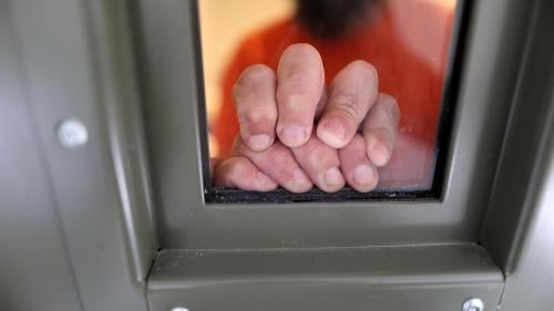 An ICE detainee rests his hands on the window of his cell in the segregation wing at the Adelanto immigration detention center, which is run by the Geo Group Inc, in Adelanto, California, on April 13, 2017.