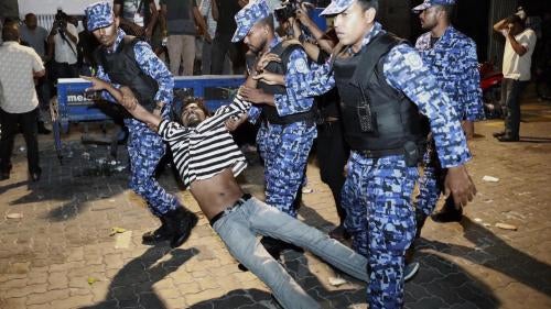 Police officers detain an opposition protester demanding the release of political prisoners during a demonstration in Malé, Maldives, February 2, 2018. 