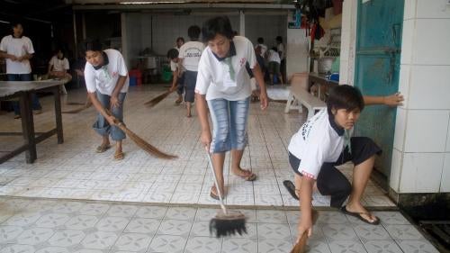 In Malang, Indonesia, prospective domestic workers clean the facilities of their training center prior to migrating for employment in Singapore, Hong Kong, and Taiwan.
