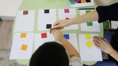 A special education teacher and a child with autism match squares at Balama Center, an organization that offers support to children with autism in Almaty, Kazakhstan. 