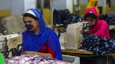 Workers sew clothes in a garments factory in Dhaka, Bangladesh, July 25, 2020.