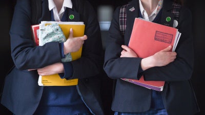 Students walk along a corridor at a school for girls in the U.K. that offers the International Baccalaureate program.