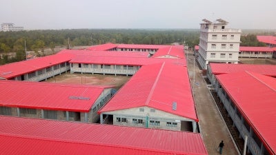 A man walks past buildings on Bhasan Char, or floating island, in the Bay of Bengal, Bangladesh on December 19, 2019.