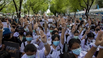 High school students salute with three-fingers, symbol of resistance during a protest rally in Bangkok, Thailand, Saturday, Sept. 5, 2020. 