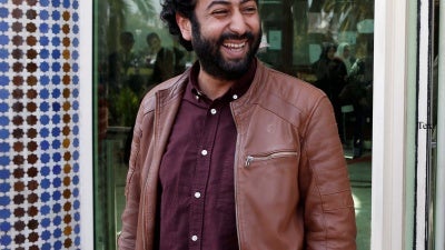 Journalist and activist Omar Radi waits outside the court in Casablanca, Morocco, March 12, 2020.