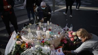 People set flowers at a memorial in front of the Notre Dame church, in Nice, France, October 30, 2020.