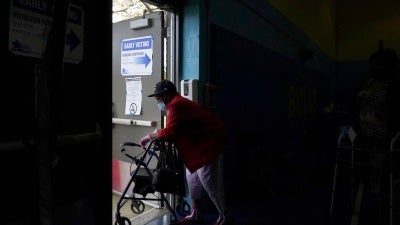 A woman departs the Beethoven Elementary School after participating in early voting in Chicago, October 15, 2020. 