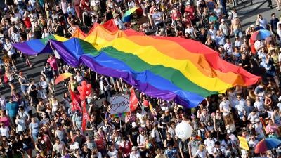 People march with a giant rainbow flag from the parliament building in Budapest during the lesbian, gay, bisexual and transgender (LGBT) Pride Parade on July 6, 2019.