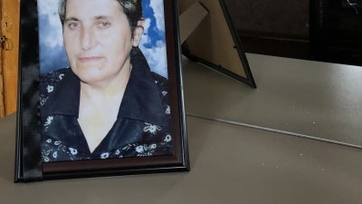 Yashar Abbasov keeps a photograph of his wife, Raziya Abbasova, on a dresser with a mirror which was damaged in the attack that killed her. 