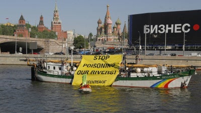 Members of the Russian branch of the environmental group Greenpeace display a protest banner in downtown Moscow on Thursday, May 20, 2010. 