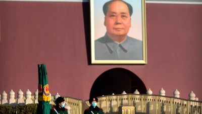 Chinese paramilitary police wearing face masks to protect against the spread of the coronavirus stand guard near the portrait of Chinese leader Mao Zedong on Tiananmen Gate near Tiananmen Square in Beijing on Saturday, January 9, 2021. 