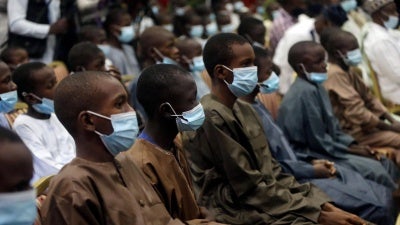 Freed schoolboys look on during a meeting with Nigeria's President Muhammadu Buhari, December 18, 2020, in Katsina, Nigeria, days after an armed group attacked their school and kidnapped them.