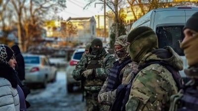 ОМОН и крымскотатарские активисты и активистки перед зданием Киевского районного суда в Симферополе. Крым, 17 февраля 2021 года.