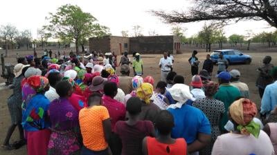 Staff from the Masvingo Centre for Research Advocacy and Development (MACRAD Trust) consult with members of the Chilonga community in Chiredzi. 