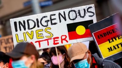 A woman holds an Indigenous Lives Matter placard during a Black Lives Matter rally on June 6, 2020 in Melbourne, Australia.