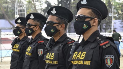 Bangladeshi RAB (Rapid Action Battalion) Dog squad unit stand on guard at the Central Shaheed Minar in Dhaka, Bangladesh. 