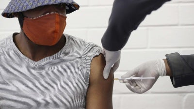 A volunteer receives a Covid-19 test vaccine injection developed at the University of Oxford in Britain, during a clinical trial at the Chris Hani Baragwanath hospital in Soweto, Johannesburg, South Africa.