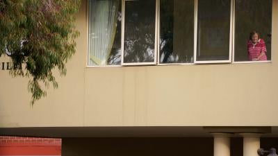 A resident looks out from the window of the Florence Aged Care Facility amid the second wave of the coronavirus disease (COVID-19) in Melbourne, Australia August 17, 2020.