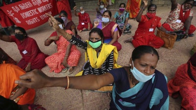 Women domestic workers, many of whom lost their jobs after the coronavirus outbreak, shout slogans at a protest demanding social security from the government in Bengaluru, India, June 15, 2020.