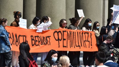 People attend a rally for the protection of women's rights in Bishkek, Kyrgyzstan, protesting the kidnapping and killing of Aizada Kanatbekova, April 8, 2021. The banner reads, "The Authorities are Responsible for Femicide."