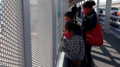 An asylum seeking family from Guatemala stands on the Paso del Norte international bridge. After border agents turned the family away at the port of entry, the family swam across the Rio Grande.