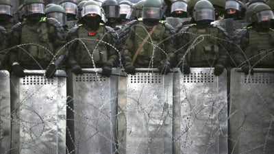 Belarusian police block a street during  opposition rally