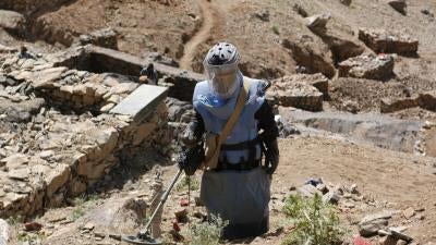 Clearance operator from the Halo Trust clearing a steep, rocky hillside in Afghanistan.