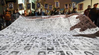 Demonstrators show photos of people killed during Brazil's dictatorship outside a police station that used to be a torture center used by the dictatorship in Sao Paulo, Brazil on August 5th, 2019.