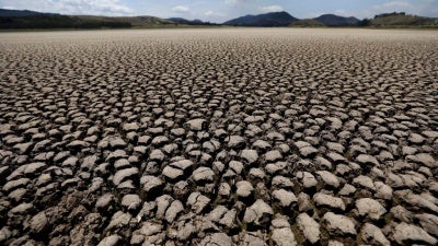 After years of very little rainfall, the lakebed of Suesca lagoon sits dry and cracked, in Suesca, Colombia, Wednesday, Feb. 17, 2021. 