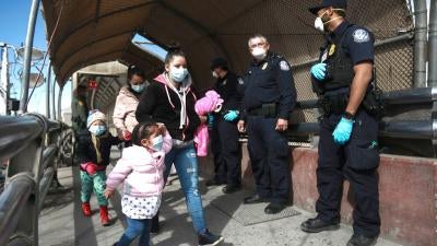 A migrant family crosses the border into El Paso, Texas, in Ciudad Juarez, Mexico, Friday, Feb. 26, 2021.