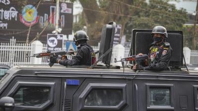 Rapid Action Battalion (RAB) officials stand alert inside a truck in front of Central Shaheed Minar in Dhaka, Bangladesh on February 20, 2021.