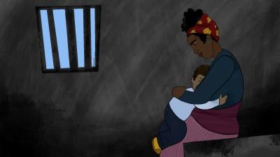 Mother holds child in prison cell