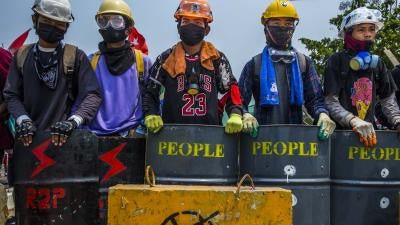 Protesters in Myanmar gather with homemade shields and protective gear to defend themselves from security forces during violent crackdowns following the military coup on February 1, 2021.