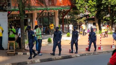 Uniformed police officers walk down a city street