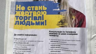 A warning leaflet in Ukrainian with a woman's face on it 
