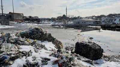 Illegally dumped plastic waste, including imported European plastic waste imports, near a residential neighborhood in Sultangazi, Istanbul, Turkey.