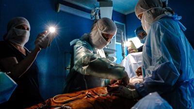 Doctors operate with phone flashlights during a power outage in Kyiv. Numerous missile and drone attacks in October and November have deprived millions of Ukrainians of at least temporary access to electricity, water, heat, and related vital services. Kyiv, November 30, 2022.  