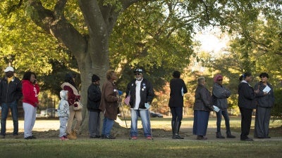 People stand in line to vote