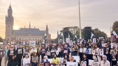 Relatives of Syrians who have been detained or disappeared protest in front of the International Court of Justice in The Hague, Netherlands, on October 10, 2023. 
