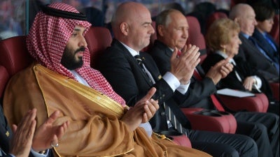 Saudi Crown Prince Mohammed bin Salman (L), FIFA President Gianni Infantino (C) and Russian President Vladimir Putin at 2018 World Cup in Moscow, June 14, 2018.