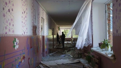  A school guard walks in the corridor of a school which was heavily damaged after a Russian airstrike in Mohrytsia, Ukraine, August 14, 2024.
