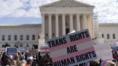 Transgender rights supporters rally outside of the Supreme Court in Washington, DC, US,  December 4, 2024.
