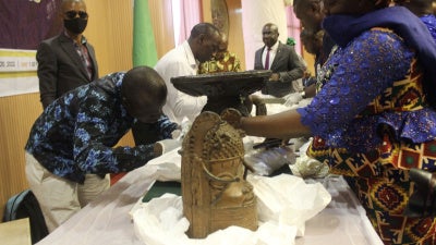 Benin bronzes looted in the past and returned to Nigeria by Germany are examined during a handing over ceremony in Abuja, December 20, 2022. 