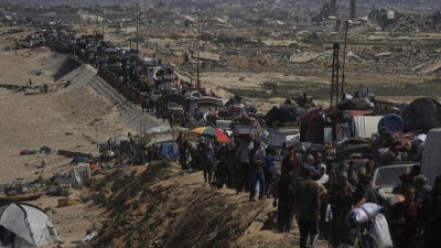 Displaced Palestinians flee northern Gaza along the coastal road toward the south, after Israel's military escalated its assault on Gaza City and warned residents to leave, September 16, 2025.