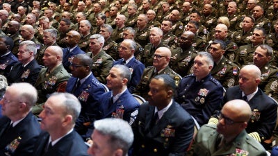 Members of the military attend a meeting convened by US Defense Secretary Pete Hegseth, at Marine Corps Base Quantico, in Quantico, Virginia, September 30, 2025.