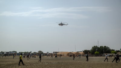 A UN helicopter performs a routine patrol over the Bentiu internally displaced persons camp in Unity State, South Sudan, on November 4, 2025.