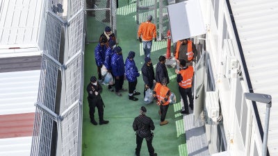 Migrants entering a detention center for processing at the port of Shengjin, northwestern Albania, January 28, 2025.